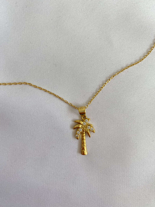 Gold necklace as a  palm tree with stones