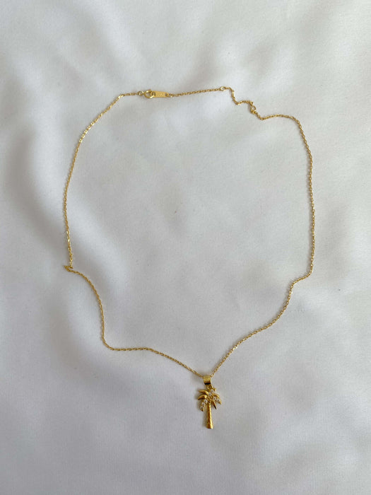 Gold necklace as a  palm tree with stones