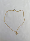 Gold necklace with stone in middle