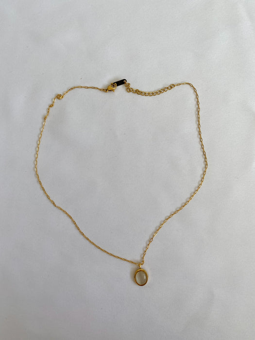 Gold necklace with stone in middle